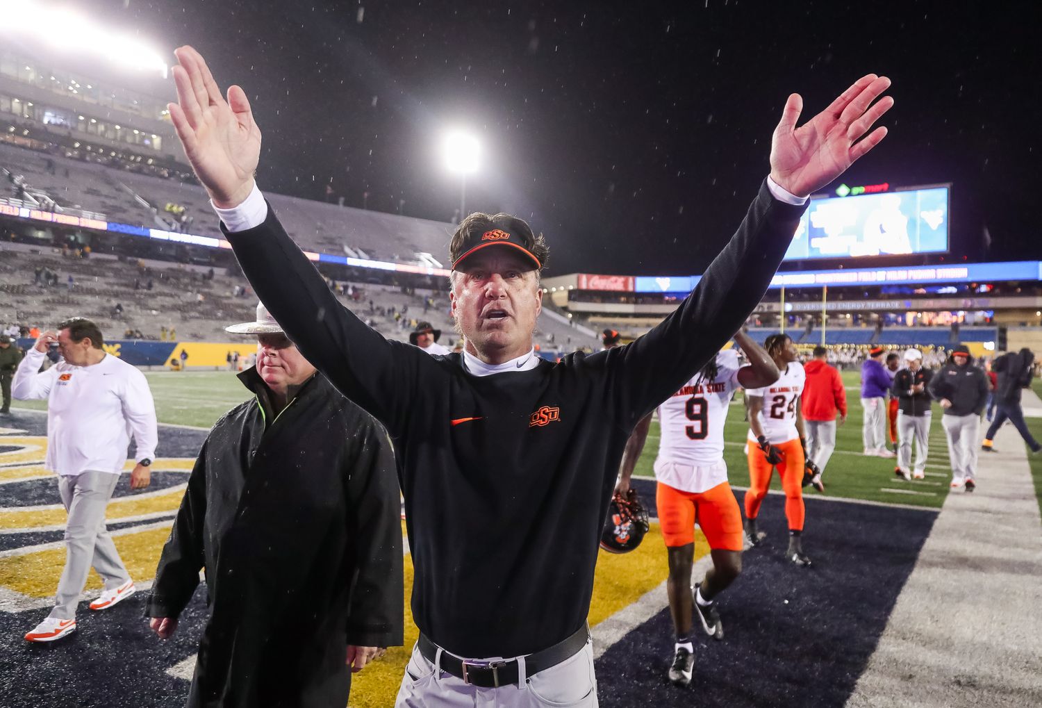 Oct 21, 2023; Morgantown, West Virginia, USA; Oklahoma State Cowboys head coach Mike Gundy celebrates with fans after defeating the West Virginia Mountaineers at Mountaineer Field at Milan Puskar Stadium. Mandatory Credit: Ben Queen-USA TODAY Sports